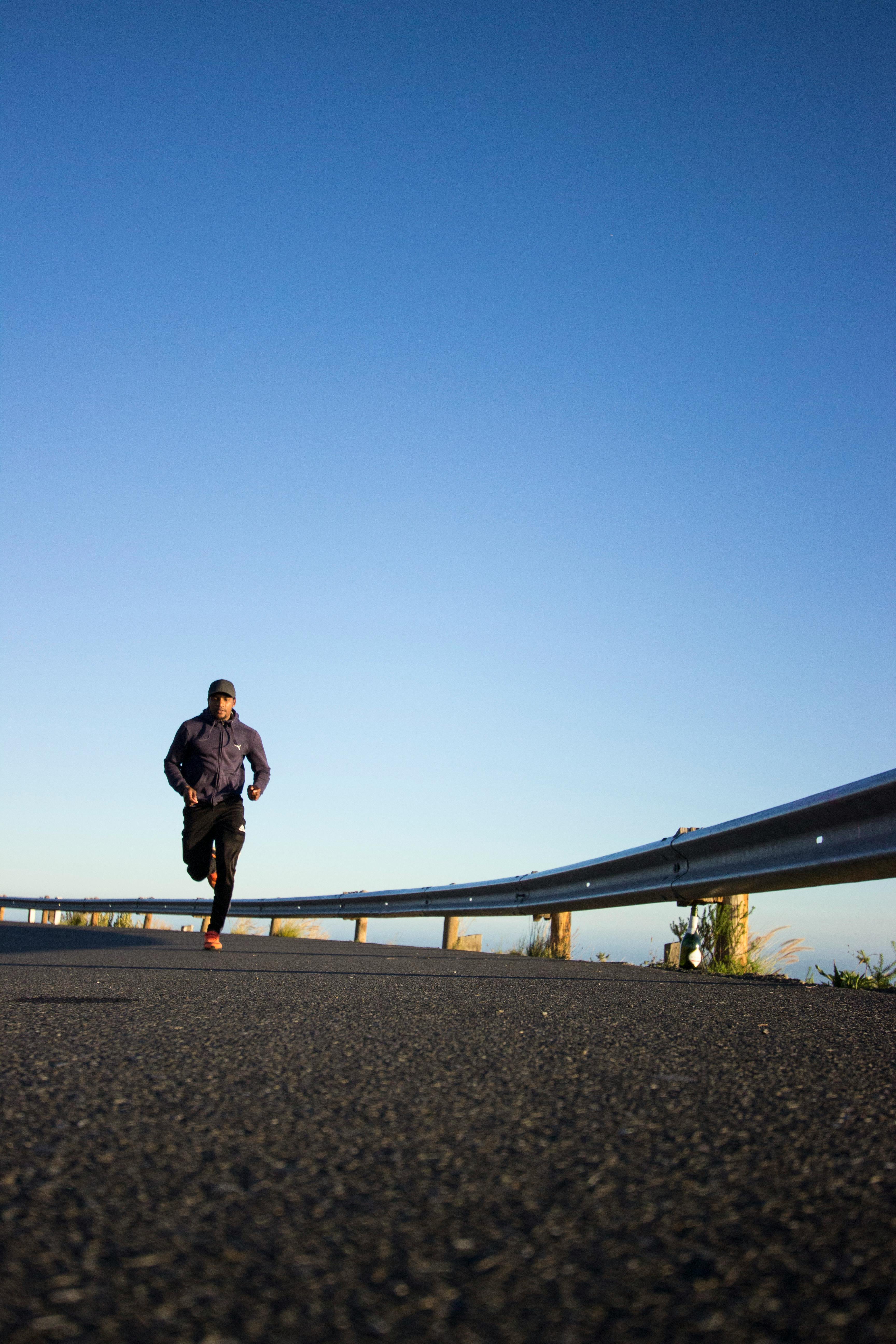 Lone runner on an open road at sunrise
